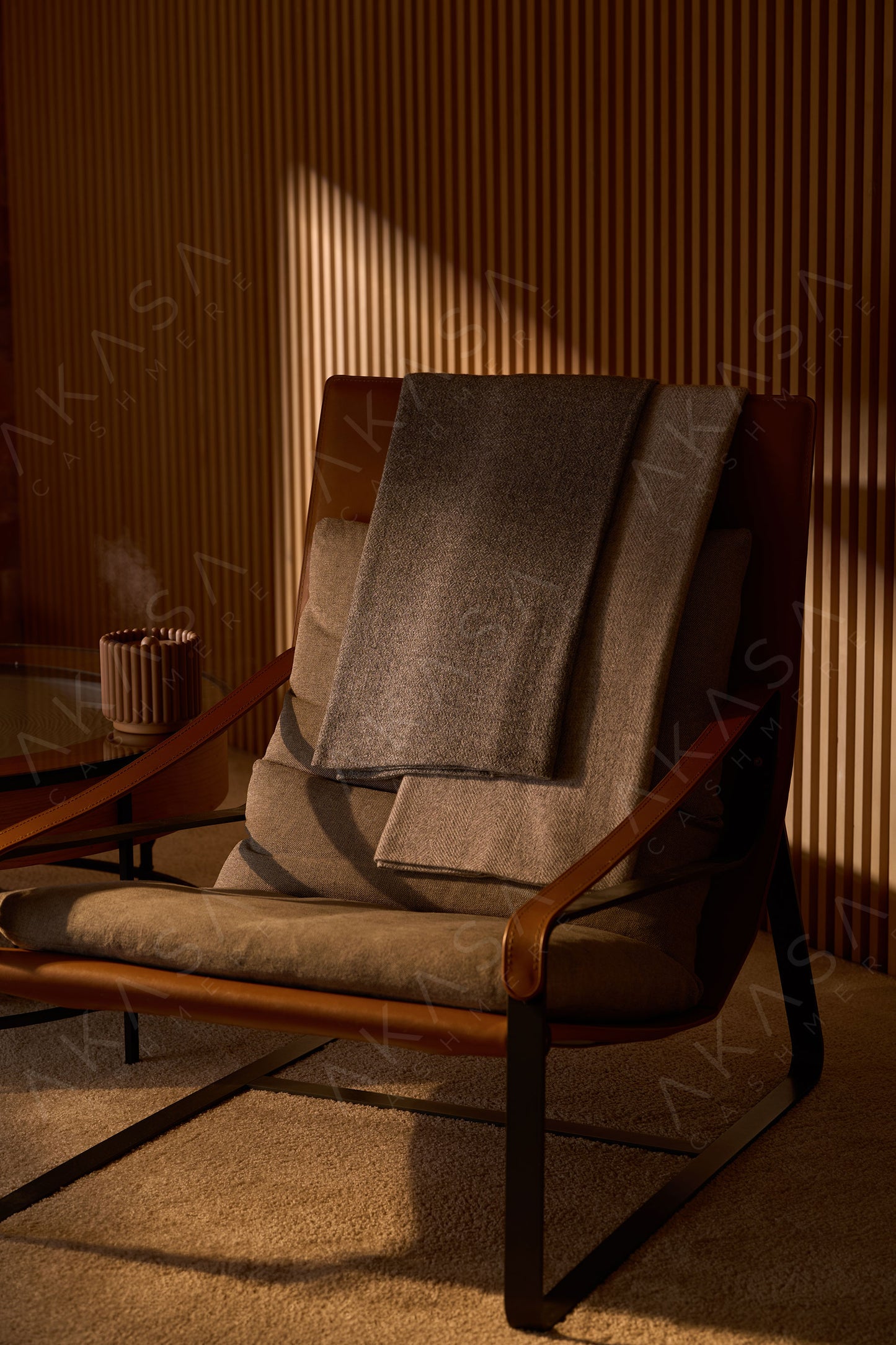 Luxury cashmere blanket styled on a sofa in a modern living room interior