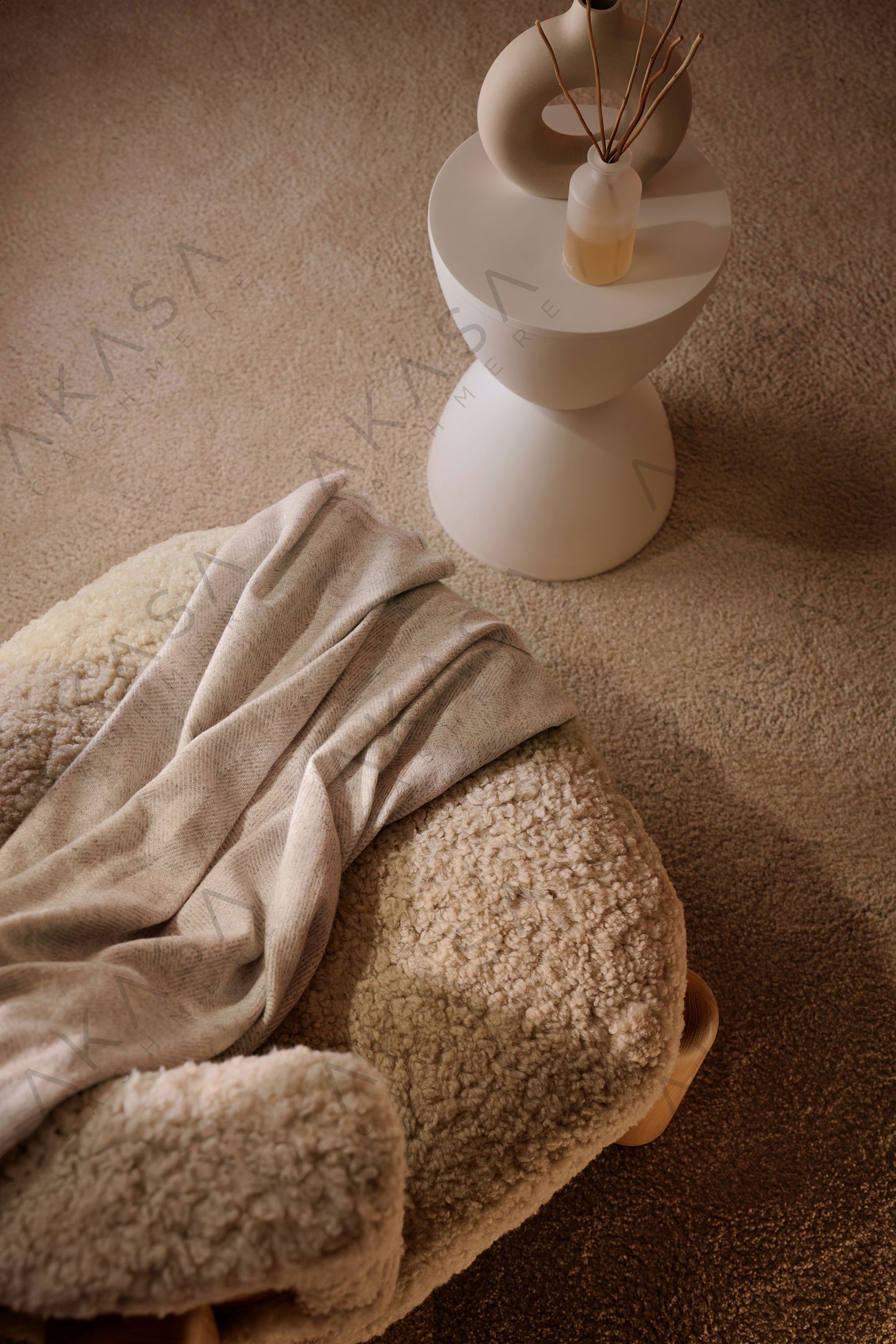 Luxury cashmere blanket styled on a sofa in a modern living room interior