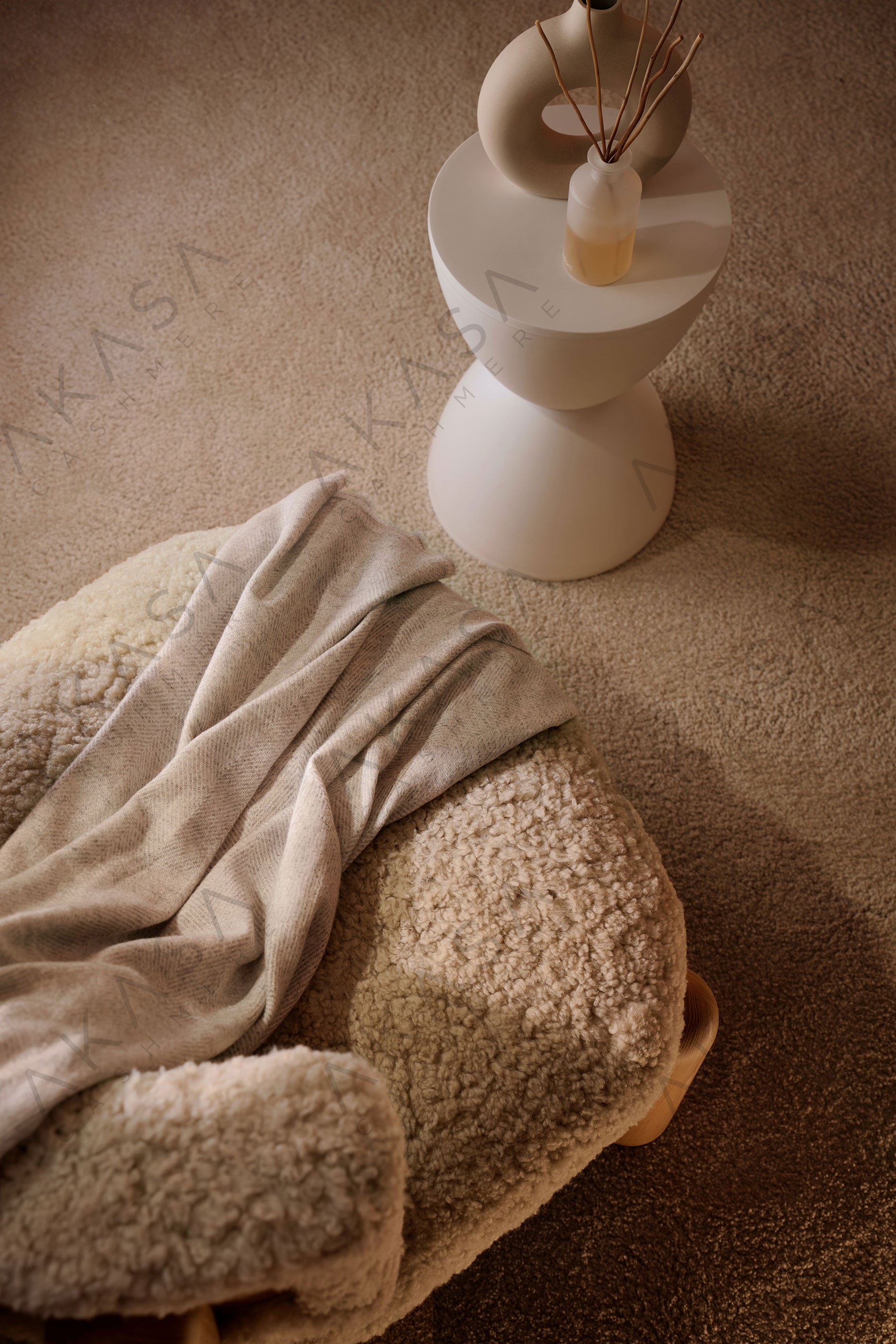 Luxury cashmere blanket styled on a sofa in a modern living room interior