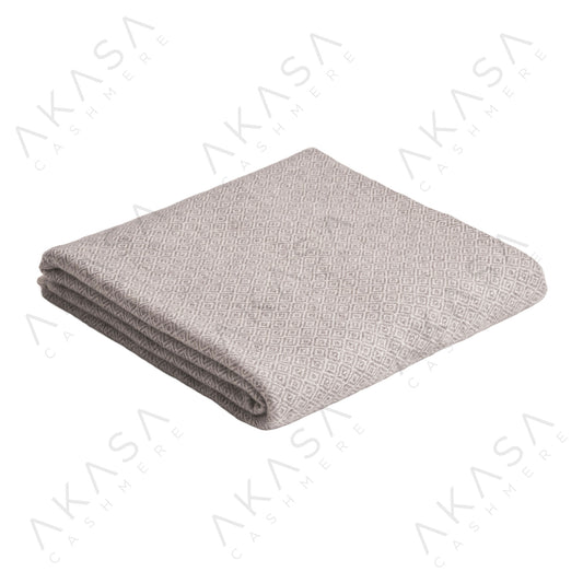 Custom cashmere blanket inspired by Himalayan heritage, crafted with traditional craftsmanship and modern luxury